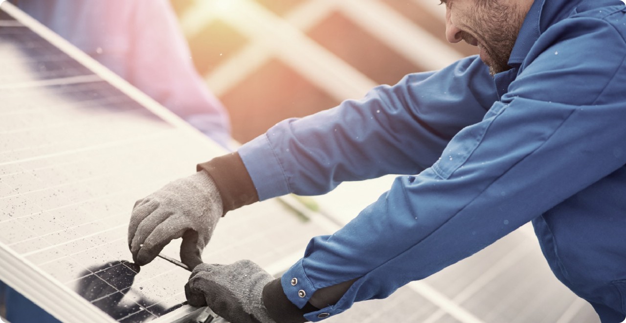 Solar installer working on panel connection
